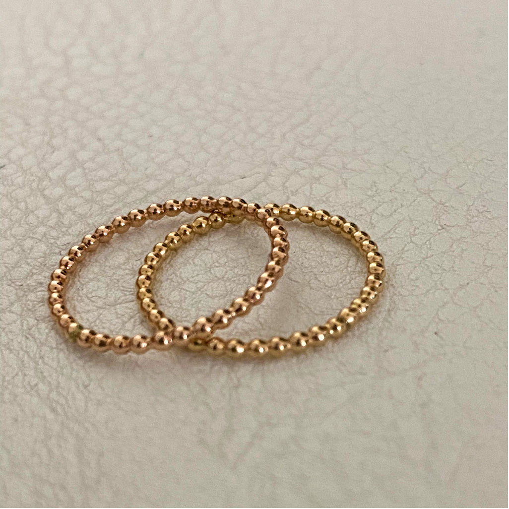 gold filled and rose gold filled beaded ring on white background.