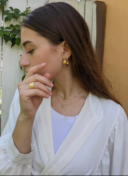 model wearing thick hammered gold filled ring.